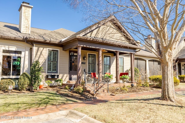 view of front of home with a porch and a front yard