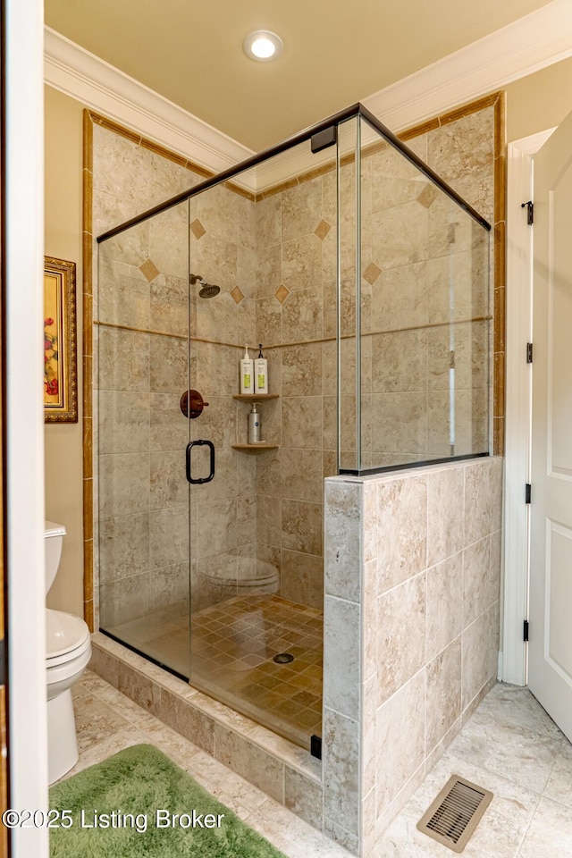 bathroom featuring an enclosed shower, crown molding, and toilet