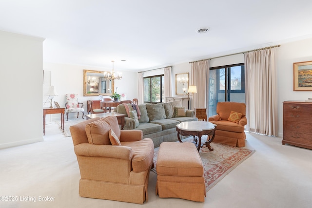 carpeted living room with a chandelier