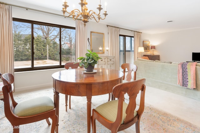 dining space with an inviting chandelier and ornamental molding