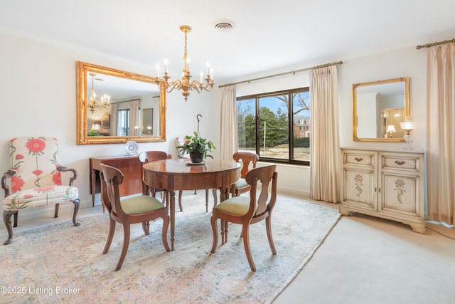 carpeted dining area featuring ornamental molding and a chandelier