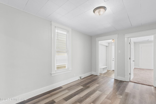 spare room with wood-type flooring