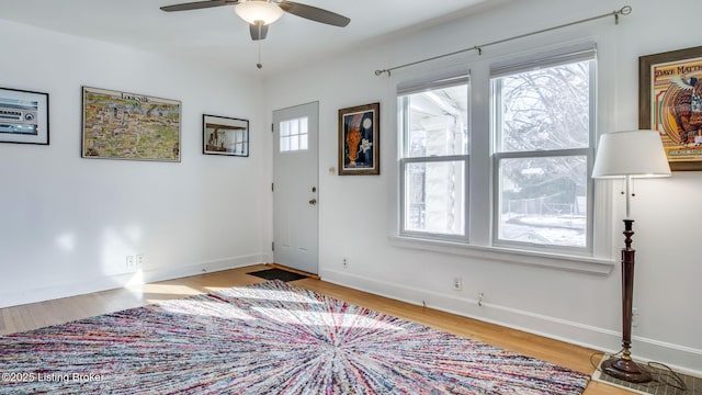 foyer with ceiling fan and light wood-type flooring