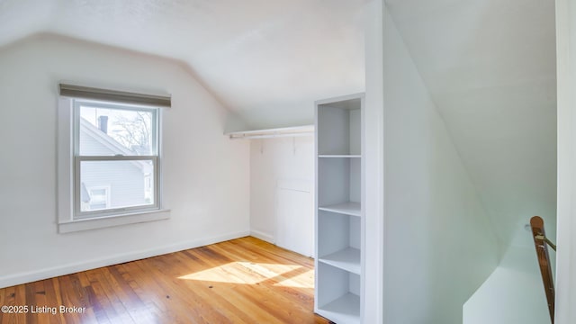 interior space with hardwood / wood-style floors and lofted ceiling