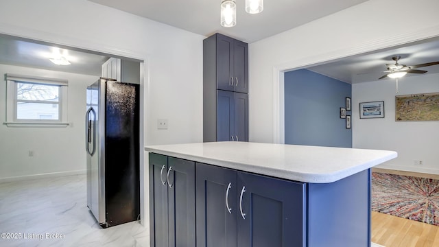 kitchen featuring ceiling fan and stainless steel refrigerator with ice dispenser