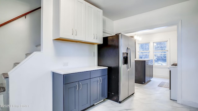 kitchen with white cabinets and stainless steel fridge with ice dispenser