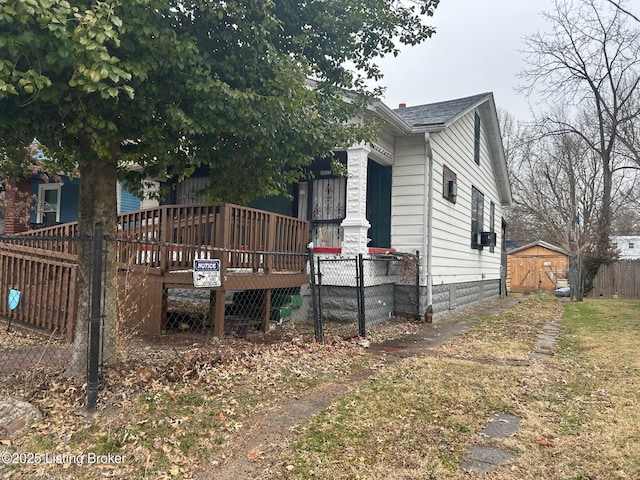 exterior space featuring a storage shed and a deck