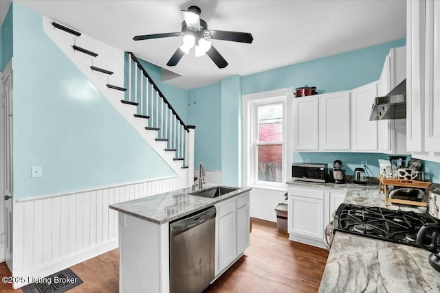 kitchen featuring extractor fan, appliances with stainless steel finishes, sink, white cabinets, and light stone counters