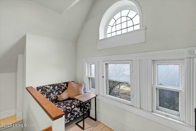 foyer entrance with lofted ceiling and light hardwood / wood-style flooring