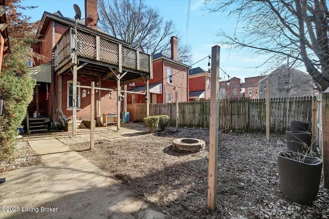 back of property featuring an outdoor fire pit