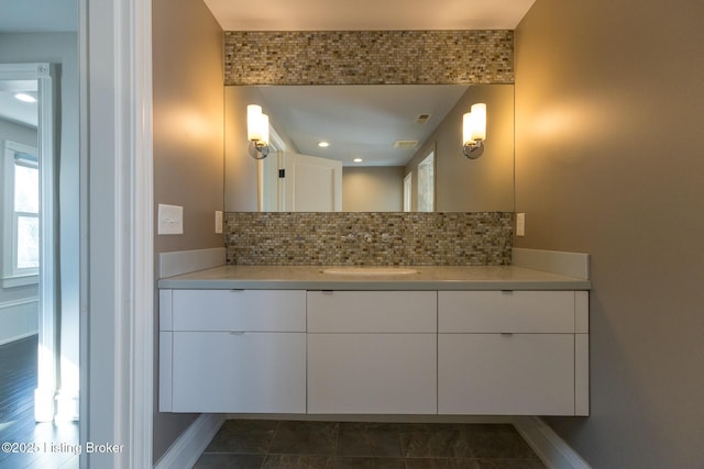 bathroom with vanity and backsplash