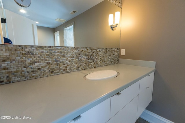 bathroom with vanity and decorative backsplash