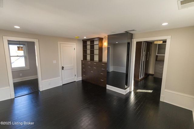 spare room featuring dark wood-type flooring