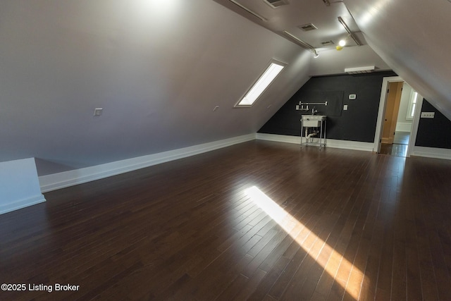 additional living space with lofted ceiling and dark hardwood / wood-style floors