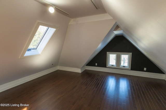 additional living space featuring lofted ceiling and dark hardwood / wood-style floors