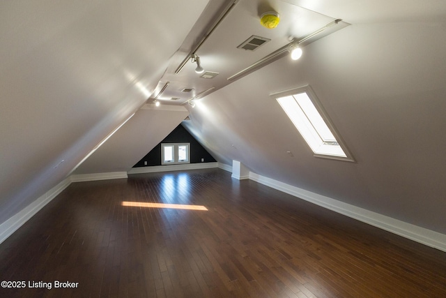 bonus room featuring dark wood-type flooring and vaulted ceiling