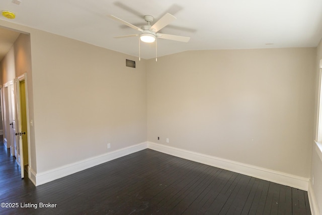 spare room featuring lofted ceiling, dark hardwood / wood-style floors, and ceiling fan