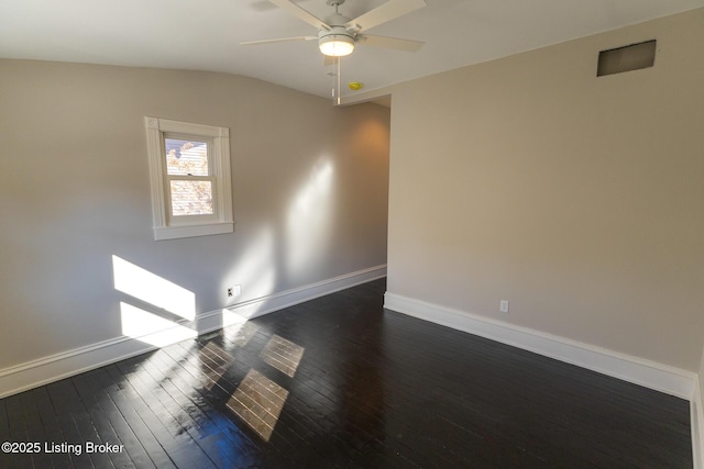 unfurnished room with vaulted ceiling, dark hardwood / wood-style floors, and ceiling fan