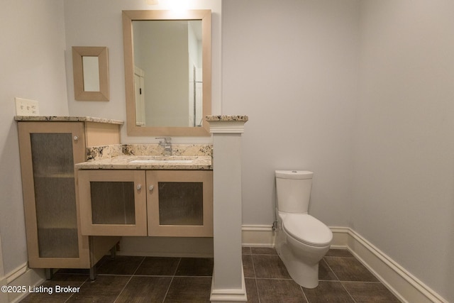 bathroom featuring tile patterned flooring, vanity, and toilet