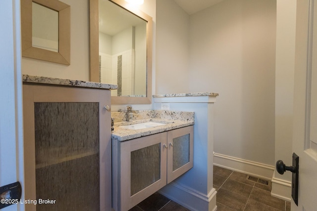 bathroom with tile patterned floors and vanity