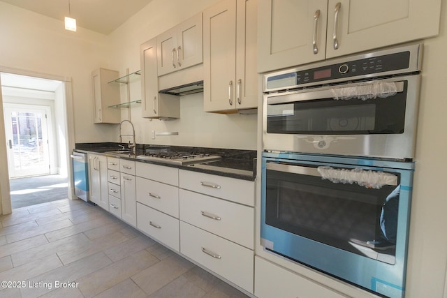 kitchen featuring stainless steel appliances, sink, and white cabinets