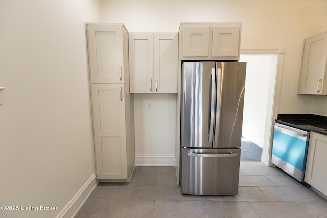 kitchen featuring light tile patterned flooring, white cabinetry, and appliances with stainless steel finishes