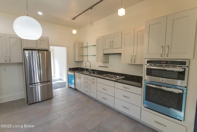 kitchen with pendant lighting, appliances with stainless steel finishes, rail lighting, and sink