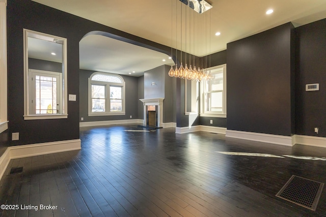 unfurnished living room with dark wood-type flooring