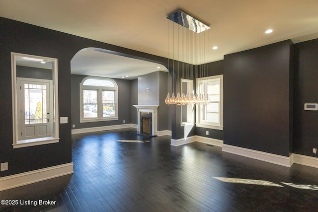 unfurnished living room with dark hardwood / wood-style floors