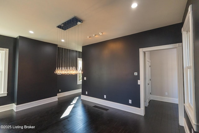 unfurnished room featuring dark wood-type flooring