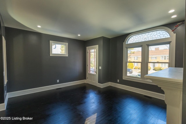 spare room featuring dark hardwood / wood-style flooring