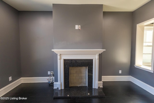 unfurnished living room with dark wood-type flooring