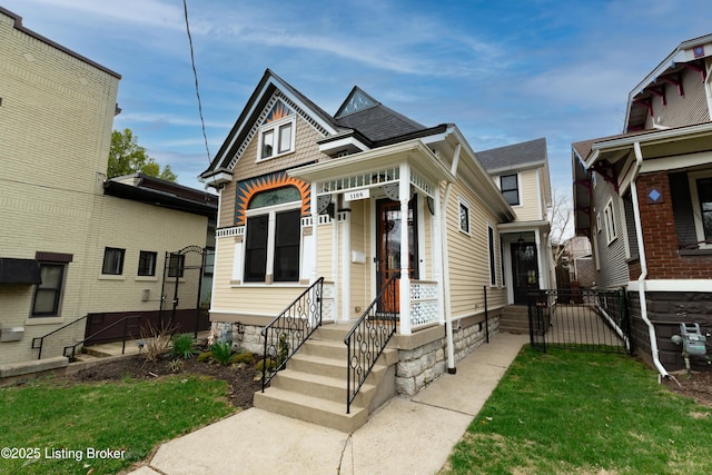 view of front facade featuring a front yard and a gate