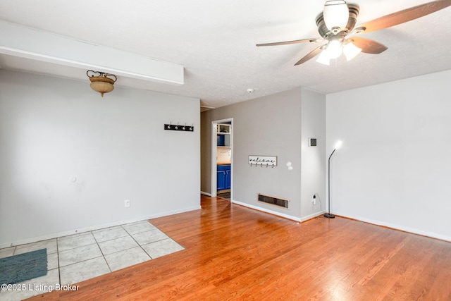 empty room with wood-type flooring and ceiling fan