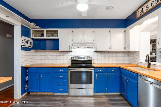 kitchen with butcher block counters, sink, stainless steel appliances, and white cabinets