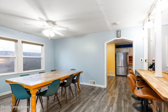 dining area featuring dark hardwood / wood-style flooring and ceiling fan