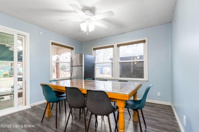 dining area featuring ceiling fan and dark hardwood / wood-style floors