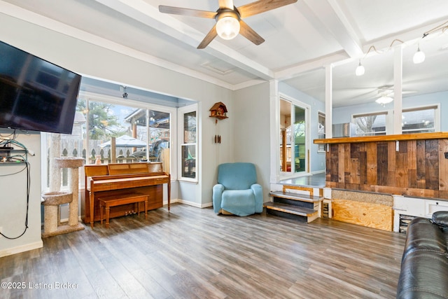 living room with beamed ceiling, wood-type flooring, and ceiling fan