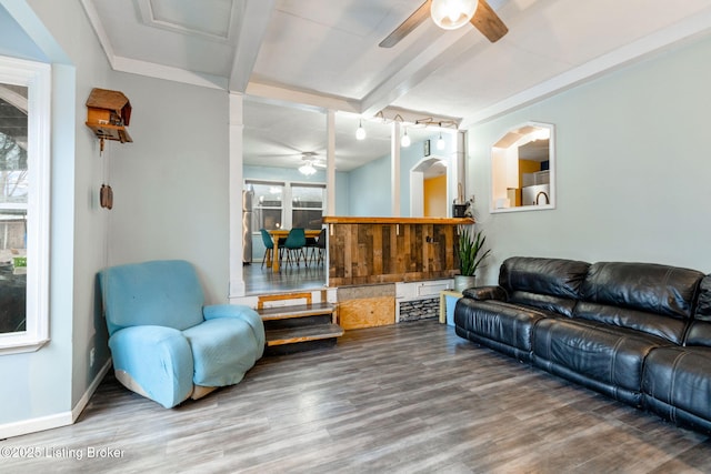 living room with beamed ceiling, wood-type flooring, and ceiling fan