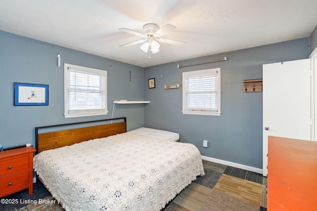 bedroom with multiple windows and ceiling fan