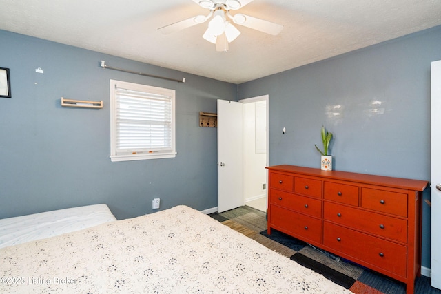 bedroom featuring dark wood-type flooring and ceiling fan