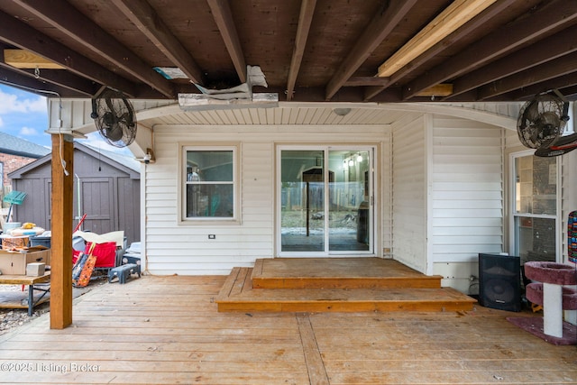 wooden terrace with a storage shed