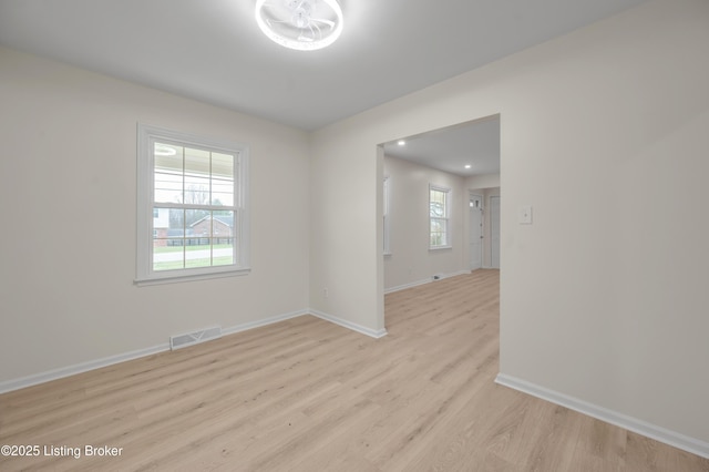 spare room with plenty of natural light and light wood-type flooring