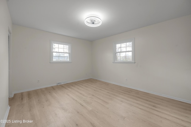 spare room featuring light hardwood / wood-style flooring