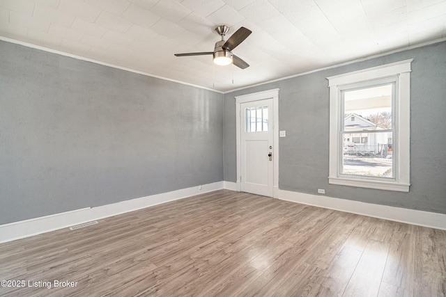 foyer featuring ornamental molding, hardwood / wood-style floors, and ceiling fan