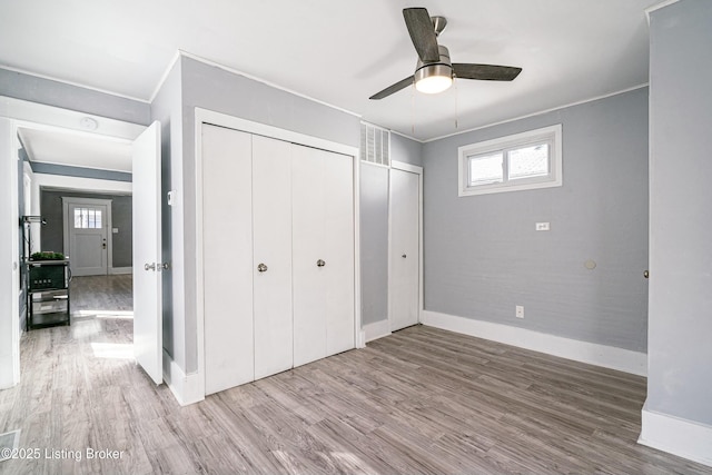 unfurnished bedroom featuring crown molding, ceiling fan, and hardwood / wood-style floors