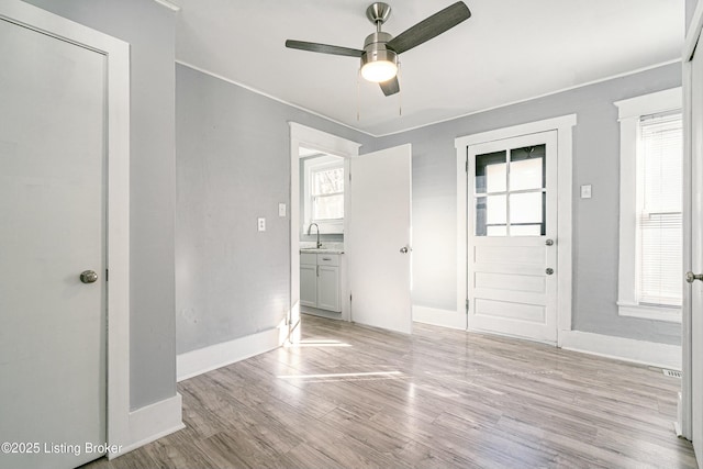 entryway with ceiling fan and light wood-type flooring