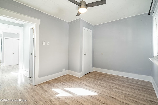 empty room with ceiling fan and light hardwood / wood-style flooring