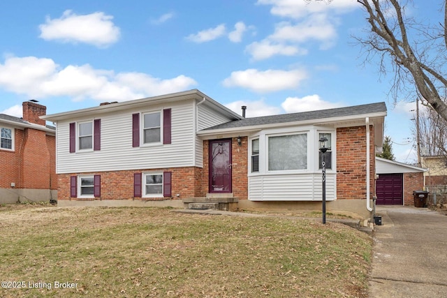 split level home with a garage and a front yard