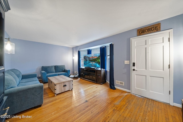 living room with light hardwood / wood-style flooring